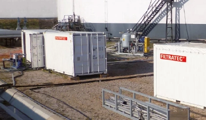 Two white containers with FILTRATEC logos on a business premises.